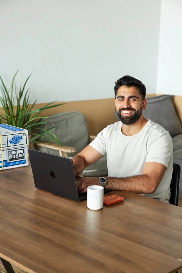 Nik Sharma smiling at his desk
